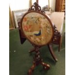 William IV rosewood and mahogany pole screen supported on three scrolling legs and a twisted