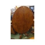 19th century walnut oval topped loo table supported on a reeded bulbous column on an shaped