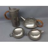 Four-piece hammered pewter Liberty & Co tea set number 0231, comprising a teapot with wicker handle,