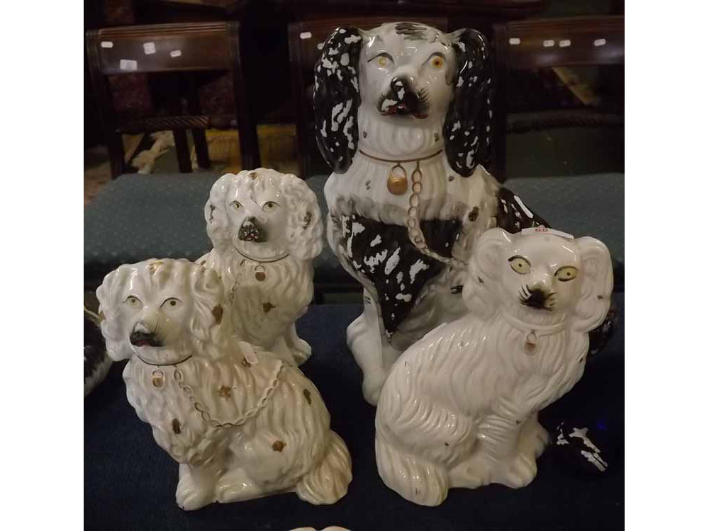 Large black and white seated Staffordshire dog together with a further pair of white and gold glazed