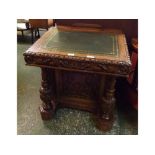 Victorian Gothic heavily carved Davenport with green leather tooled insert, with three drawers to