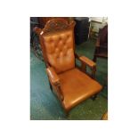 Edwardian walnut carved armchair with tan leatherette upholstered seat, button back and arms, carved