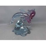 20th century coloured glass model of dolphins leaping out of the waves, signed to the foot "Pino