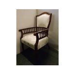 Edwardian mahogany armchair with rail sides and shield back, cream and floral upholstered seat and