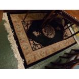 Small Chinese wool rug, floral border on a black field, 48ins x 73ins