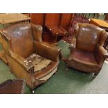 Pair of early 20th century tan leather upholstered wing back armchairs with button detail on