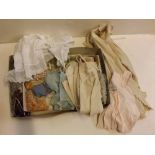 Box containing vintage baby clothing and assorted fabrics etc