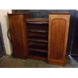 Victorian mahogany drop-centred bookcase centrally fitted with open shelves, flanked either side