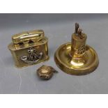Two brass table lighters and a further smaller example (3)