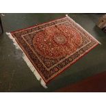 Keshan floor rug decorated with central red lozenge, floral detailing, 74ins x 55ins