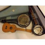 Chinese made miniature acoustic guitar, together with two cased miniature banjos, one a/f and one