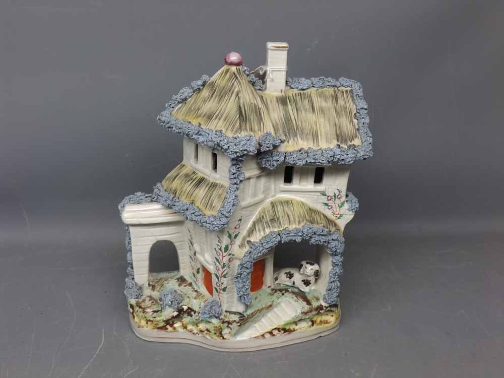 19th century Staffordshire flat back model of a cottage with dog seated in archway, 10ins tall