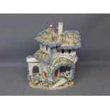 19th century Staffordshire flat back model of a cottage with dog seated in archway, 10ins tall
