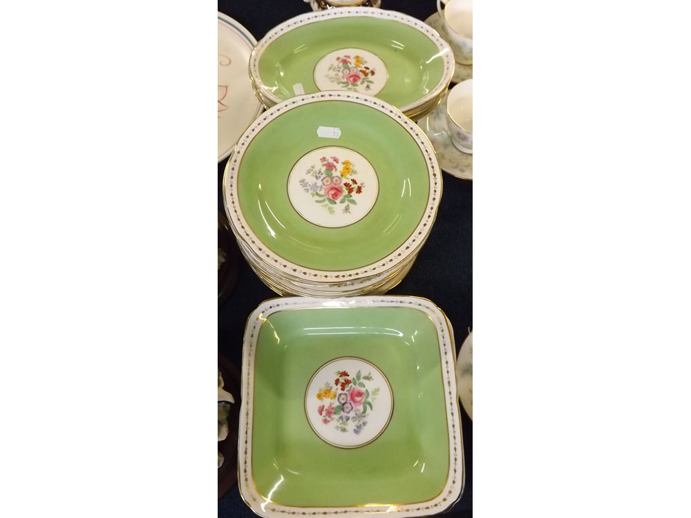 Decorative part dessert set, all with floral centres within green gilded borders