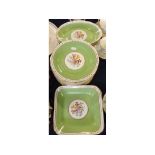 Decorative part dessert set, all with floral centres within green gilded borders