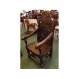 Early 20th century oak wainscot chair with heavily carved rose panelled back, initial "WNDG",