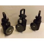 Three various black anodised railway lamps