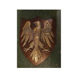 Decorative wall mounted bronze eagle plaque with splayed wings and leg, mounted with three crowns on