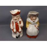 Two Staffordshire jugs modelled as Punch and Judy (a/f), 9 1/2 ins tall