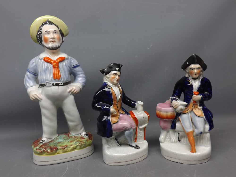 Large Staffordshire figure of a sailor together with a pair of smaller seated Naval figures with