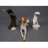 Three USSR made figures of an otter with a fish, a further white glazed stoat and a seated Great