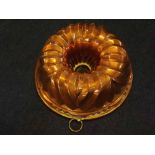 19th Century Victorian copper jelly mould of circular form with a ribbed decoration, 11ins diameter