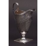 George III milk jug of helmet form with cast and applied reeded rim, strap work handle on