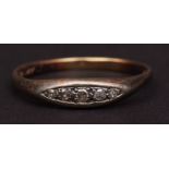 Antique precious metal and five stone diamond ring, having five graduated single cut small diamonds,