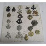 Mixed Lot: 122 cap badges mainly British Infantry regiments of First War period, together with
