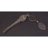 Late 19th century mother of pearl and gilt metal mounted folding lorgnette, the grips decorated with