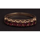 9ct gold and seven stone ruby ring, the pierced raided gallery set with seven small circular