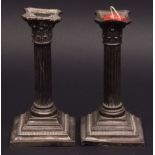 Two American white metal candlesticks each modelled in the form of a Corinthian column with