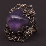 Vintage white metal and amethyst dress ring, the large polished cabochon amethyst set in an ornate