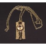 Vintage stylised gilt metal and crystal pendant and chain, the textured rectangular panel with a