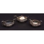 Late Victorian part cruet set comprising two open salts and lidded mustard, each of lobed oval