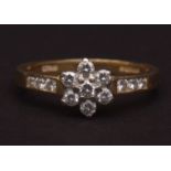 Modern 18ct gold and diamond cluster ring, the seven small brilliant cut diamonds set in a flower