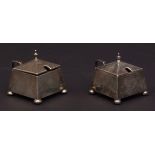 Two George V mustards, each of faceted and square form, each with hinged cover, cast and applied