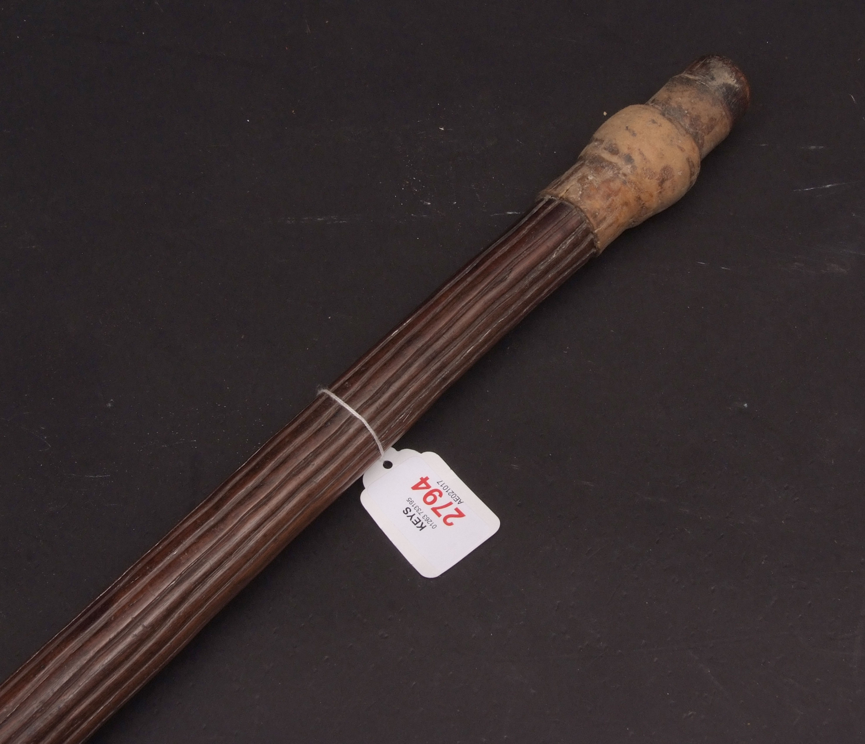 Australian aboriginal? digging stick with fluted shaft to a polished point and hide covered