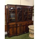 Reproduction mahogany break fronted bookcase, top fitted with four astragal glazed doors, base