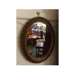 Oval composition wall hanging mirror with foliage relief to borders, 14ins x 18ins