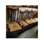 Mid-20th Century oak set of four dining chairs with bobbin and turned detail and rush seats