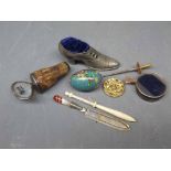 Box containing mixed shoe formed pin cushion, a silver and mother of pearl gin stopper, a cloisonn