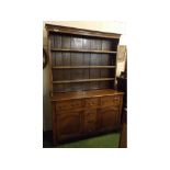 18th century oak dresser, top fitted with three fixed shelves with panelled back and base fitted