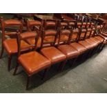 Set of sixteen oak bar back dining chairs with tan rexine upholstered seats and backs, with