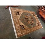 @Modern Horiz carpet with green and cream ground, floral decoration round a central lozenge, 280 x