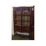 Edwardian mahogany serpentine fronted display cabinet fitted with two glazed doors with satinwood