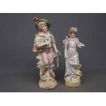 Pair of bisque German painted figures of a young man wearing a cap and a further figure of a lady