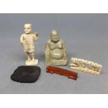 Bag containing a soapstone carved model of a Buddha together with a further ivory Oriental carved