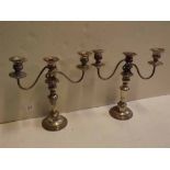 Pair of silver plated on copper three-branch candelabrum, on a circular stepped base with a