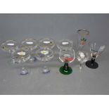 Set of six Babycham glasses together with a pink lady printed glass with black stem and base and